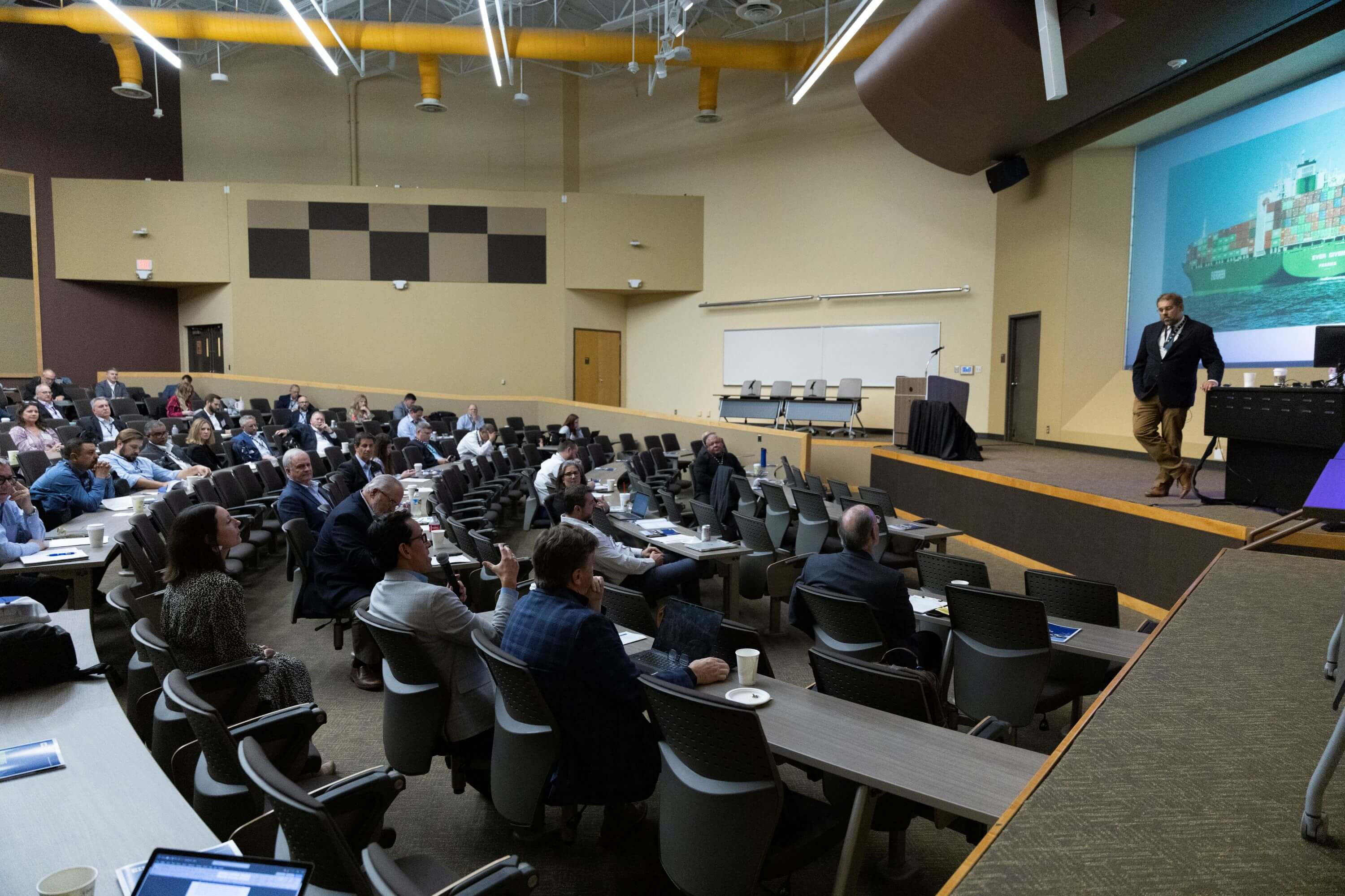 Wide shot of Spring BOA attendees in an auditorium